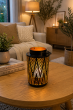 Load image into Gallery viewer, Black decorative LED lantern with geometric cutwork pattern and warm ambient candle light for modern home décor