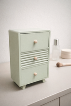 Load image into Gallery viewer, Sage green wooden mini drawer organizer on bedside table with soft lighting