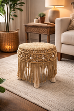 Load image into Gallery viewer, Handwoven macramé stool with fringe and wooden legs in boho living room