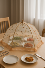 Load image into Gallery viewer, 30-inch floral mesh food cover umbrella placed over plates on a wooden dining table