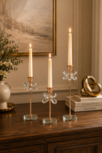Load image into Gallery viewer, Crystal Bloom 3-piece rose gold candle holder set with lit taper candles on wooden console sideboard