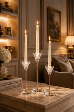 Load image into Gallery viewer, Diamond Glow 3-piece crystal candle holder set with lit taper candles on marble coffee table in living room