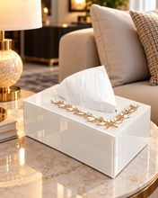 Load image into Gallery viewer, White glass tissue box with gold-tone crystal leaf accent on a marble coffee table