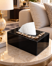Load image into Gallery viewer, Black glossy glass tissue box with gold-tone crystal leaf accent on a coffee table