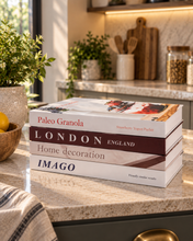 Load image into Gallery viewer, 4 piece decorative fake book set stacked and upright on open shelf display with home decor accessories