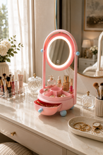 Load image into Gallery viewer, Pink Lumi LED vanity mirror and makeup organizer with touch-controlled oval mirror, divided tray and pull-out storage drawer, measuring 23 × 11.5 × 10 inches.