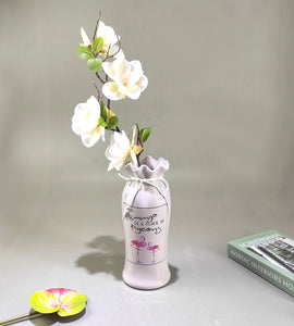 Artificial flower arrangement in ceramic vase