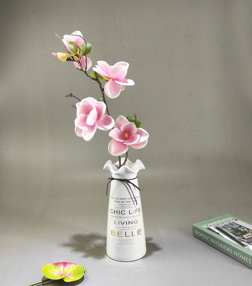 Artificial flower arrangement in quoted ceramic vase