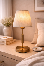 Load image into Gallery viewer, Modern gold table lamp with fabric shade on bedside table