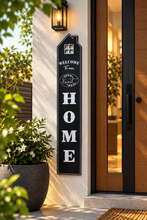 Load image into Gallery viewer, Black Nordic Welcome Home vertical wall sign, 47 × 8 inches, displayed beside modern wooden entrance door – Metaphor BD