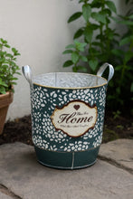 Load image into Gallery viewer, Green vintage metal planter bucket with white dot pattern and “Home” emblem, dual handles