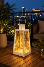 Load image into Gallery viewer, White decorative metal and glass LED lantern with warm fairy lights measuring 7 inches high and 4.5 inches wide for modern home décor