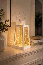 Load image into Gallery viewer, White decorative metal and glass LED lantern with warm fairy lights measuring 7 inches high and 4.5 inches wide for modern home décor