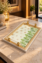 Load image into Gallery viewer, Botanical floral tray with green tropical leaves, a textured gold-tone border and transparent handles on a stone counter.