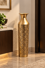 Load image into Gallery viewer, Golden metal floor vase showing intricate floral and geometric filigree detailing and a flared neck.