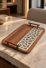 Load image into Gallery viewer, Walnut-brown decorative tray with rounded corners, ivory geometric inset and matching raised handles on a veined tabletop.