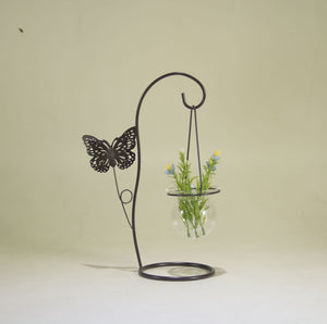 Vintage style metal plant holder with artificial flowers