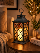 Load image into Gallery viewer, Black decorative LED lantern with warm candle light effect and glass panels for living room and bedroom décor
