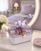 Load image into Gallery viewer, Bow Belle pink portable makeup and jewellery organizer with transparent lid, divided compartments, gold-toned clasp and bow handle – MetaphorBD
