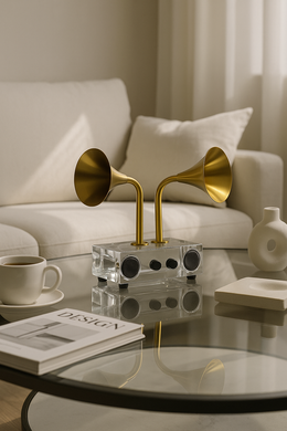 Dual gold-horn gramophone-inspired acrylic showpiece on a glass coffee table with modern decor