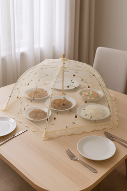 30-inch floral mesh food cover umbrella placed over plates on a wooden dining table