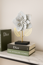 Load image into Gallery viewer, &quot;Metal flower sculpture with white layered petals and golden leaves on black base&quot;
