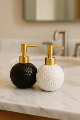 Round white ceramic soap dispenser with embossed leaf pattern and gold pump from MetaphorBD.