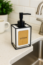 Load image into Gallery viewer, Minimalist white lotion dispenser with bamboo front and black metal frame – MetaphorBD bathroom decor

