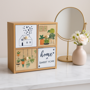 Small 4-drawer wooden organizer with illustrated fronts and round knobs on a tabletop