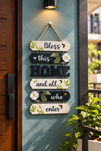 Load image into Gallery viewer, Decorative Bless This Home wooden welcome sign hanging beside a modern wooden entrance door with floral and bee illustrations – Metaphor BD
