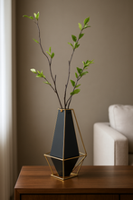 Load image into Gallery viewer, Black and gold geometric metal vase with artificial flower arrangement – modern home décor.
