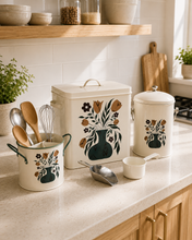 Load image into Gallery viewer, 4-piece floral metal kitchen storage set with cream botanical design displayed on open wooden pantry shelves.
