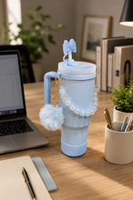 Load image into Gallery viewer, Blue Pookie bow 1L tumbler with straw, handle and pom-pom charm in aesthetic desk setup – MetaphorBD
