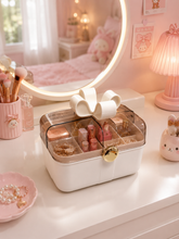 Load image into Gallery viewer, Bow Belle lavender portable makeup organizer with transparent lid and bow handle beside vanity mirror – MetaphorBD
