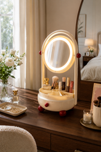 Load image into Gallery viewer, Pink Lumi LED vanity mirror and makeup organizer with illuminated oval glass mirror, divided tray and pull-out drawer on a dressing table.
