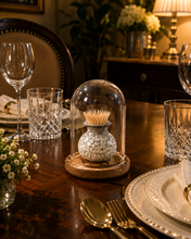Load image into Gallery viewer, A decorative tabletop scene in a warmly lit dining room. A small speckled ceramic vase filled with toothpicks sits under a clear glass cloche on a round wooden base, placed on a dark wood table with plates, cutlery, glasses, and flowers around it.11
