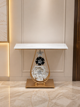 Load image into Gallery viewer, Luxury marble top console table with gold metal frame and decorative floral base for modern home interiors.
