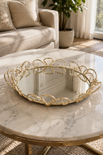 Load image into Gallery viewer, Luxury round gold mirror decorative tray with elegant metal scrollwork frame and mirrored glass base for coffee table, vanity, console table, and luxury home décor.
