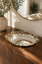 Load image into Gallery viewer, Luxury round gold mirror decorative tray with elegant metal scrollwork frame and mirrored glass base for coffee table, vanity, console table, and luxury home décor.

