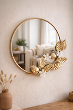 Load image into Gallery viewer, Luxury round wall mirror with gold metal floral frame measuring 32 x 27 inches for elegant living room and entryway décor1
