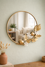 Load image into Gallery viewer, Luxury round wall mirror with gold metal floral frame measuring 32 x 27 inches for elegant living room and entryway décor
