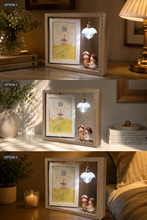 Load image into Gallery viewer, Three lifestyle options for a wooden shadow box night light, shown side-by-side in warm bedroom settings. Each option features a lighted interior with a small illustrated picture, two cute figurines, and a hanging bulb that glows when switched on.
