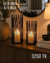 Load image into Gallery viewer, Two black metal candle holders with a wavy branch-like pattern, shown lit on a wooden shelf in a styled interior setting. Text overlays indicate sizes 10/4 inch and 8/4 inch, and the model number 3250 TK.
