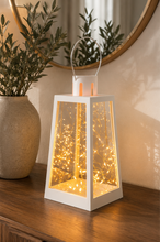 Load image into Gallery viewer, White decorative metal and glass LED lantern with warm fairy lights measuring 7 inches high and 4.5 inches wide for modern home décor
