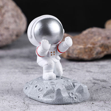 Cute astronaut phone holder standing on moon base – MetaphorBD desk accessory