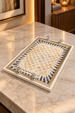Load image into Gallery viewer, Ivory and beige floral mosaic-look tray with black geometric accents and transparent handles, styled near flowers.
