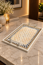 Load image into Gallery viewer, Floral mosaic-look decorative tray with a champagne-gold-tone frame and transparent handles on a veined counter.
