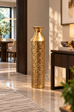 Load image into Gallery viewer, Golden openwork metal floor vase standing beside a console in an elegant foyer.
